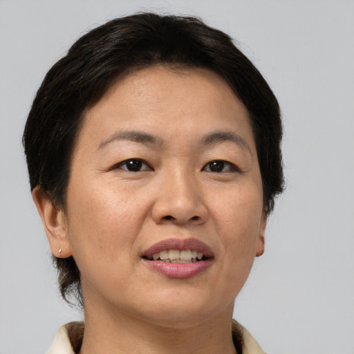 Joyful asian adult female with short  brown hair and brown eyes
