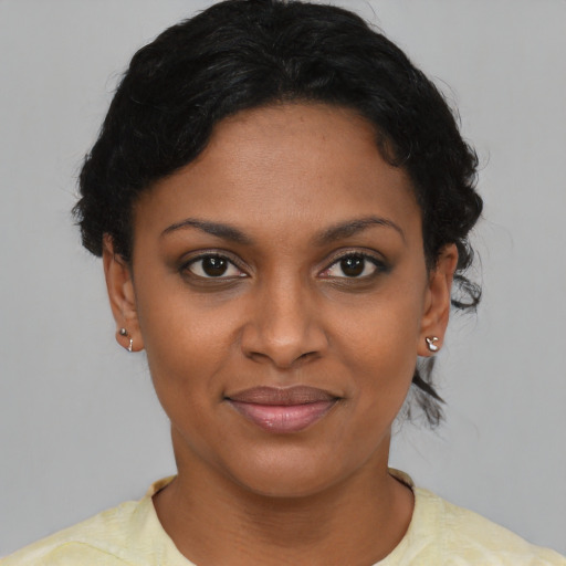 Joyful latino young-adult female with short  brown hair and brown eyes