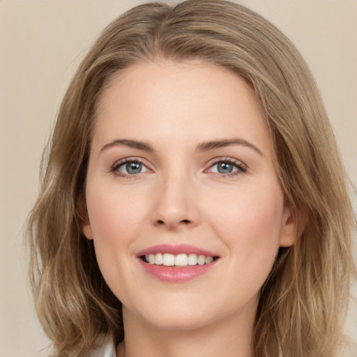 Joyful white young-adult female with medium  brown hair and green eyes