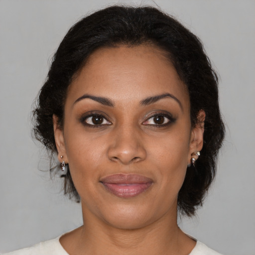 Joyful black young-adult female with medium  brown hair and brown eyes