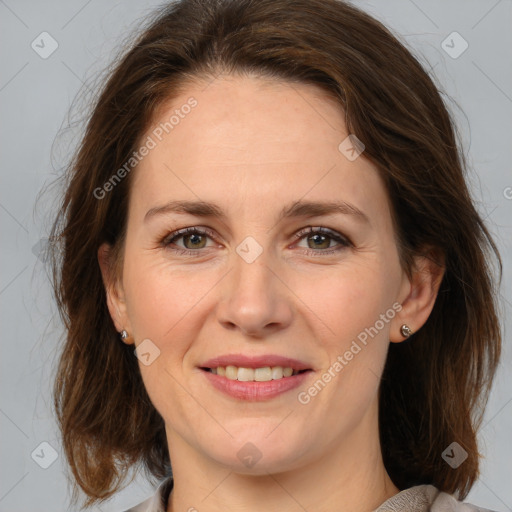 Joyful white adult female with medium  brown hair and grey eyes