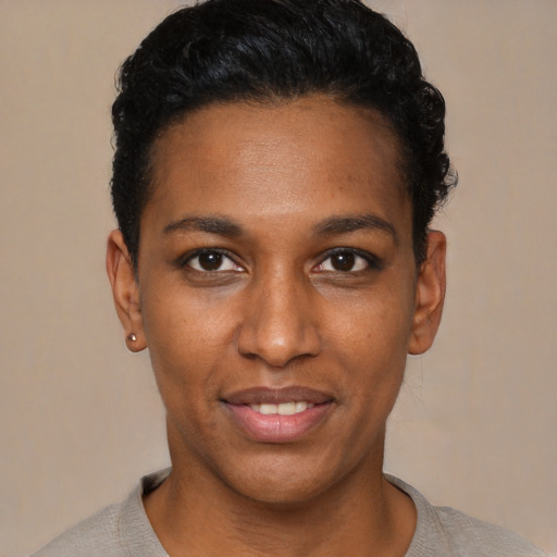 Joyful black young-adult female with short  black hair and brown eyes