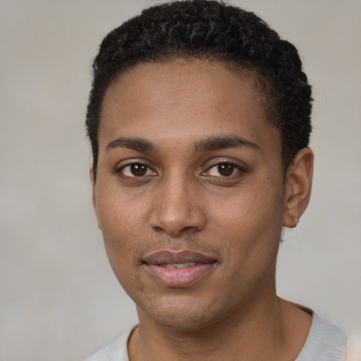 Joyful black young-adult male with short  black hair and brown eyes