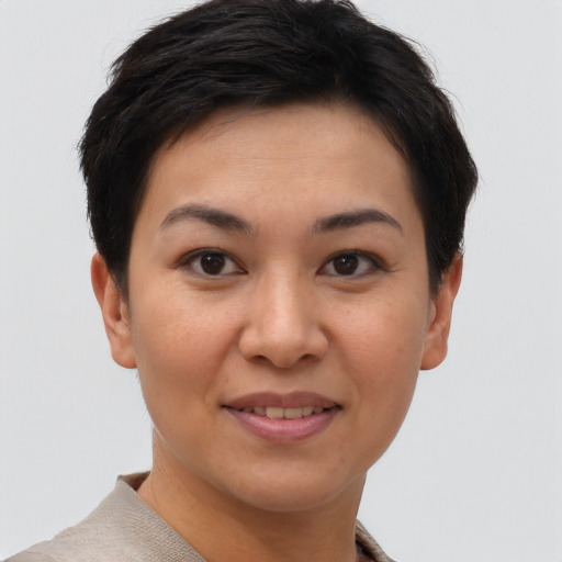 Joyful asian young-adult female with short  brown hair and brown eyes