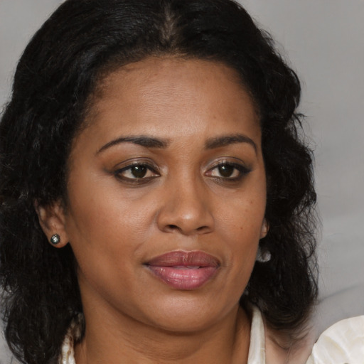 Joyful black young-adult female with medium  brown hair and brown eyes