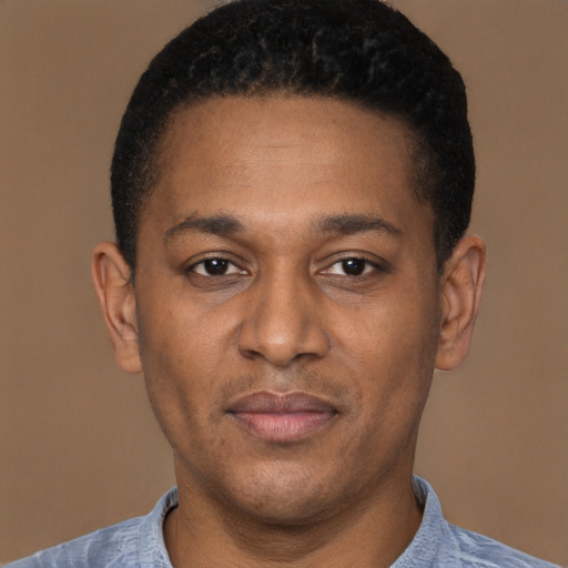 Joyful latino young-adult male with short  brown hair and brown eyes