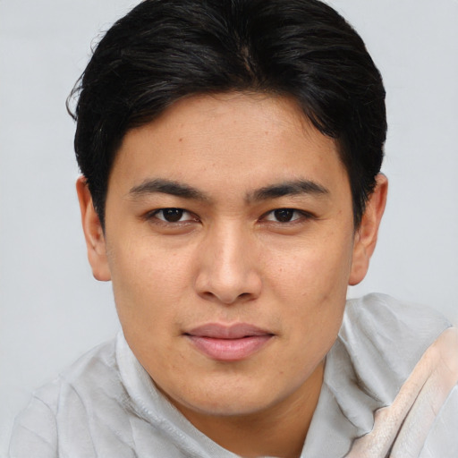 Joyful asian young-adult male with short  brown hair and brown eyes