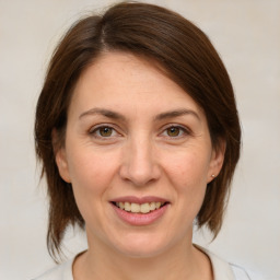 Joyful white adult female with medium  brown hair and brown eyes