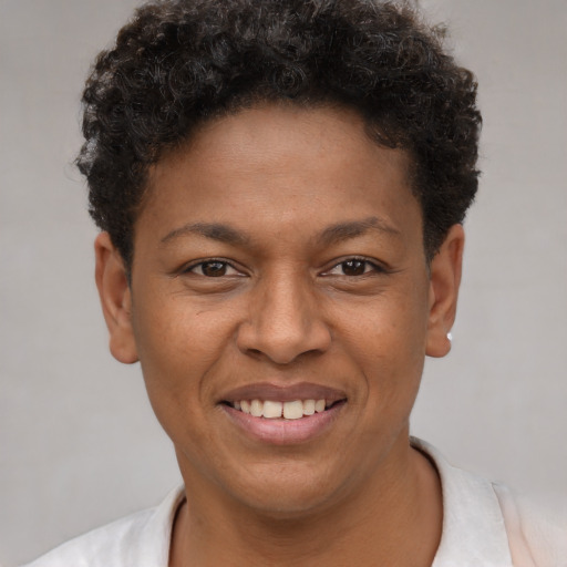 Joyful black young-adult male with short  brown hair and brown eyes