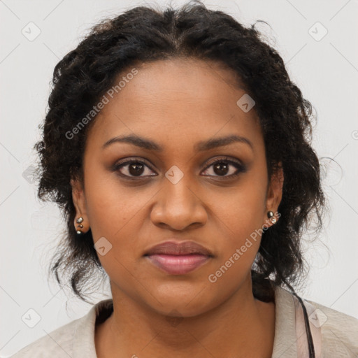 Joyful black young-adult female with long  brown hair and brown eyes