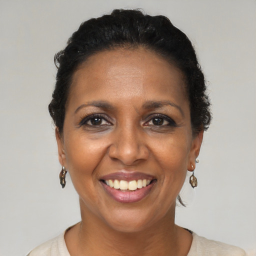 Joyful black adult female with short  brown hair and brown eyes
