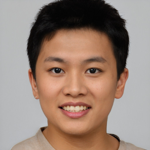 Joyful asian young-adult male with short  brown hair and brown eyes