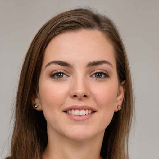 Joyful white young-adult female with long  brown hair and grey eyes