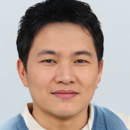 Joyful asian young-adult male with short  brown hair and brown eyes