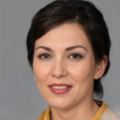 Joyful white young-adult female with medium  brown hair and brown eyes