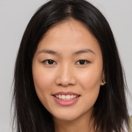 Joyful asian young-adult female with long  brown hair and brown eyes