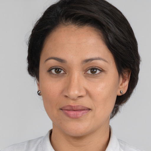 Joyful white adult female with medium  brown hair and brown eyes