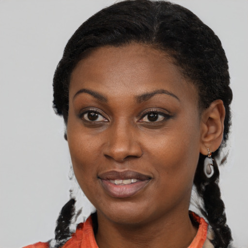 Joyful black young-adult female with medium  brown hair and brown eyes