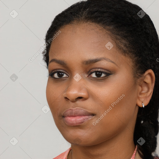 Joyful black young-adult female with long  brown hair and brown eyes