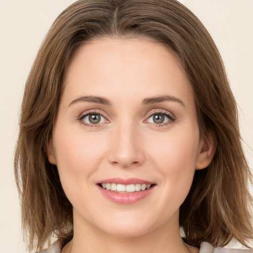 Joyful white young-adult female with long  brown hair and green eyes