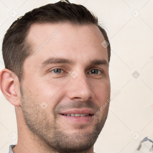 Joyful white young-adult male with short  brown hair and grey eyes