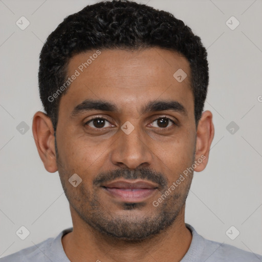 Joyful black young-adult male with short  black hair and brown eyes