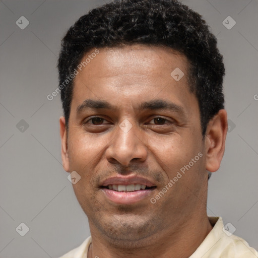 Joyful latino adult male with short  brown hair and brown eyes