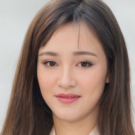 Joyful asian young-adult female with long  brown hair and brown eyes