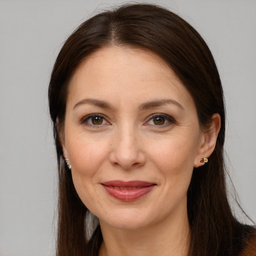 Joyful white adult female with long  brown hair and brown eyes