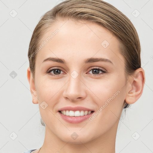 Joyful white young-adult female with short  brown hair and grey eyes