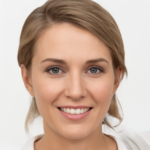 Joyful white young-adult female with medium  brown hair and grey eyes