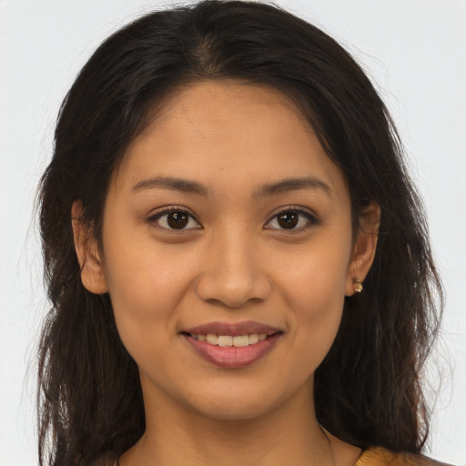 Joyful latino young-adult female with long  brown hair and brown eyes
