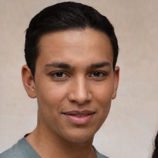 Joyful white young-adult male with short  black hair and brown eyes