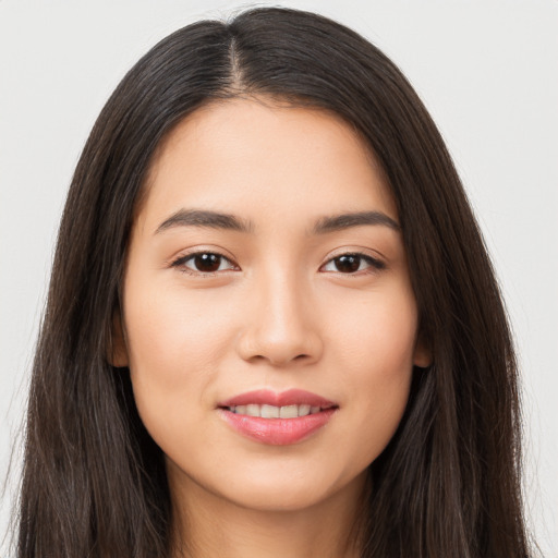 Joyful asian young-adult female with long  brown hair and brown eyes