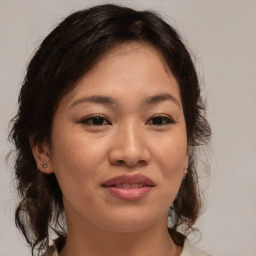 Joyful asian young-adult female with medium  brown hair and brown eyes