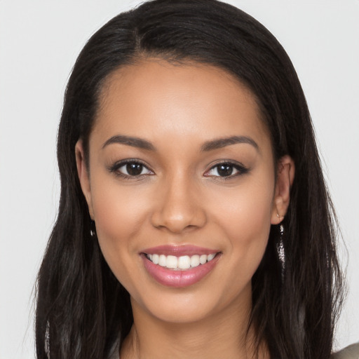 Joyful latino young-adult female with long  black hair and brown eyes