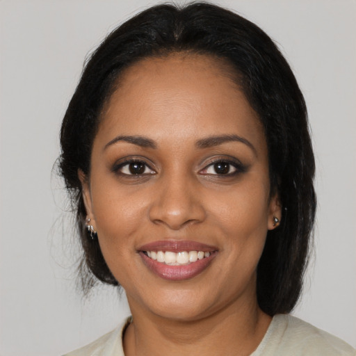 Joyful black young-adult female with medium  black hair and brown eyes
