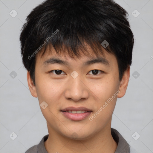 Joyful asian young-adult male with short  brown hair and brown eyes