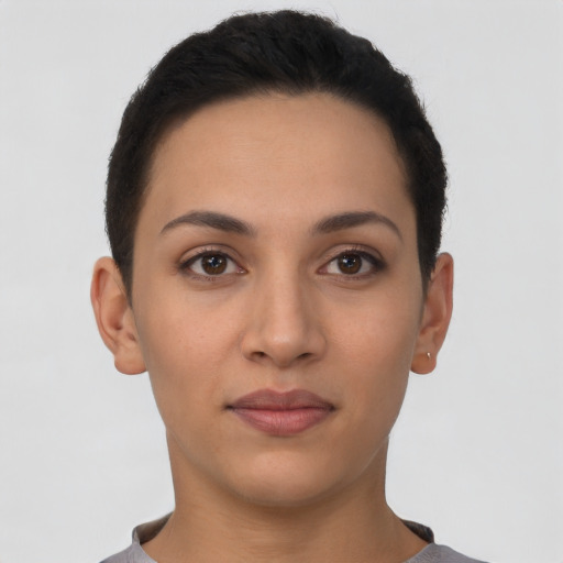 Joyful latino young-adult female with short  brown hair and brown eyes