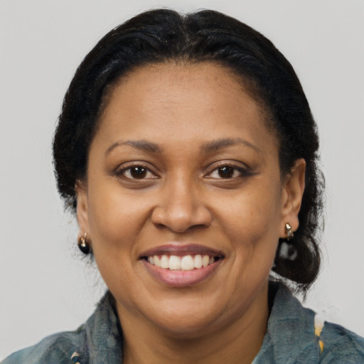 Joyful latino adult female with medium  brown hair and brown eyes
