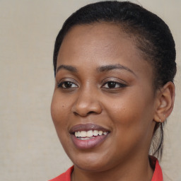 Joyful black young-adult female with long  brown hair and brown eyes