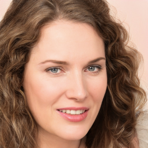 Joyful white young-adult female with long  brown hair and green eyes