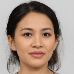 Joyful asian young-adult female with medium  brown hair and brown eyes