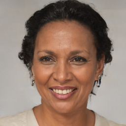 Joyful black adult female with medium  brown hair and brown eyes