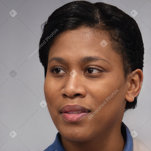 Joyful black young-adult female with short  black hair and brown eyes