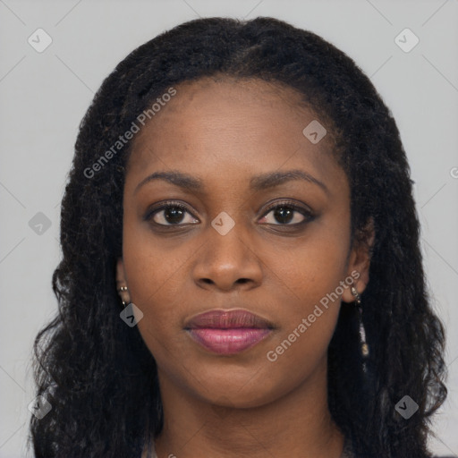 Joyful black young-adult female with long  black hair and brown eyes