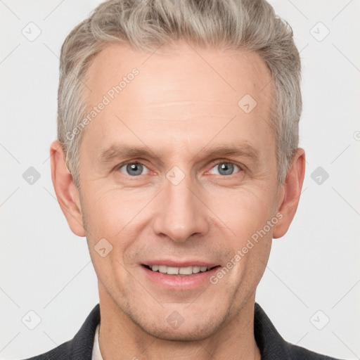 Joyful white adult male with short  brown hair and grey eyes