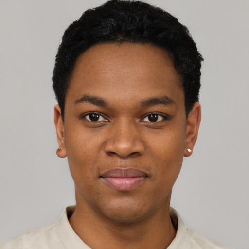Joyful black young-adult male with short  black hair and brown eyes