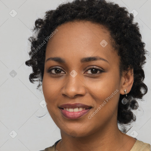 Joyful black young-adult female with long  black hair and brown eyes