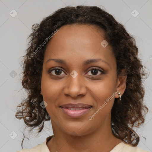 Joyful black young-adult female with long  brown hair and brown eyes